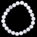 A beaded stretch bracelet made of white marble-like white howlite gemstone beads with subtle gray veining, displayed against a solid black background.
