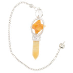A silver-toned chain necklace featuring a yellow jasper point & merkaba pendulum with a faceted orange star-shaped, set in ornate silver filigree.